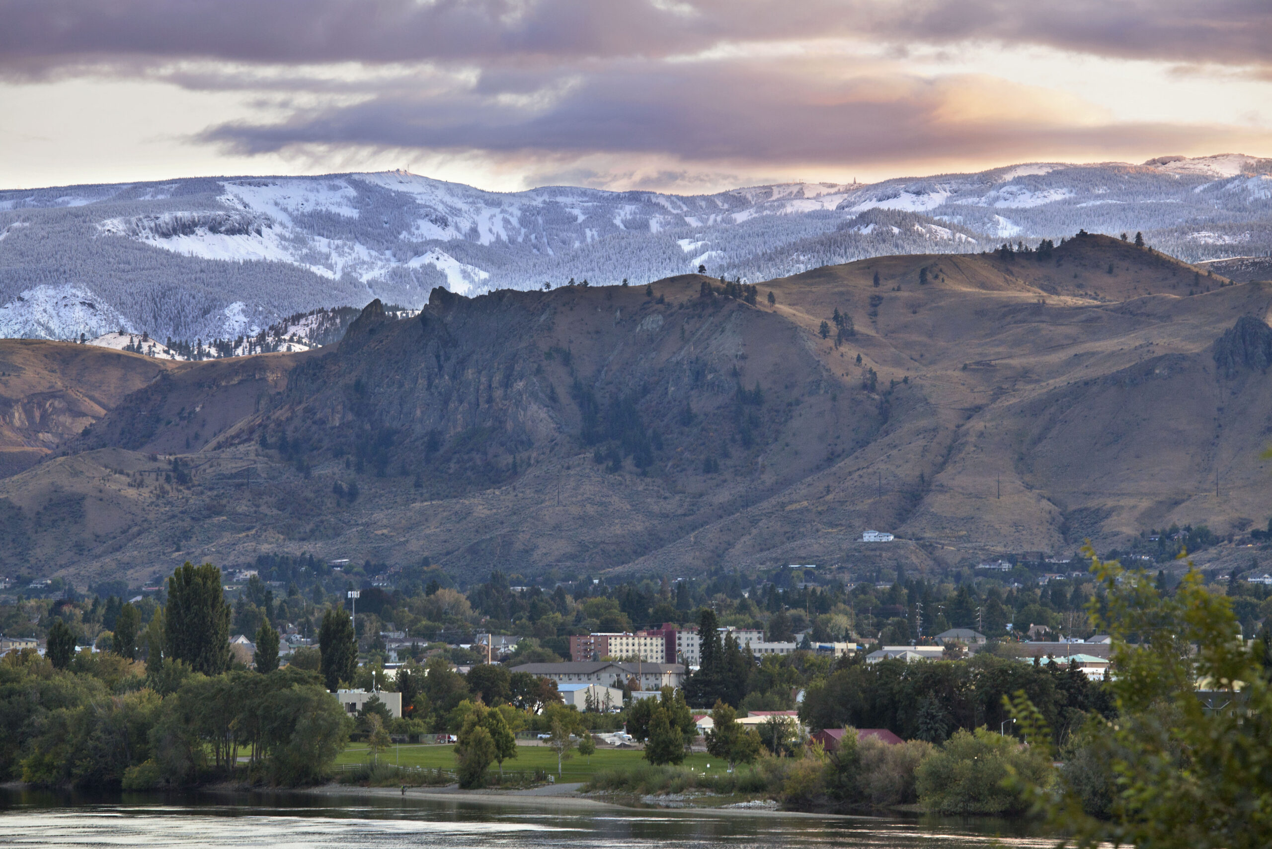 View of Mission Ridge and Wenatchee in the Spring. Wenatchee is green with new growth and Mission Ridge is covered in snow.