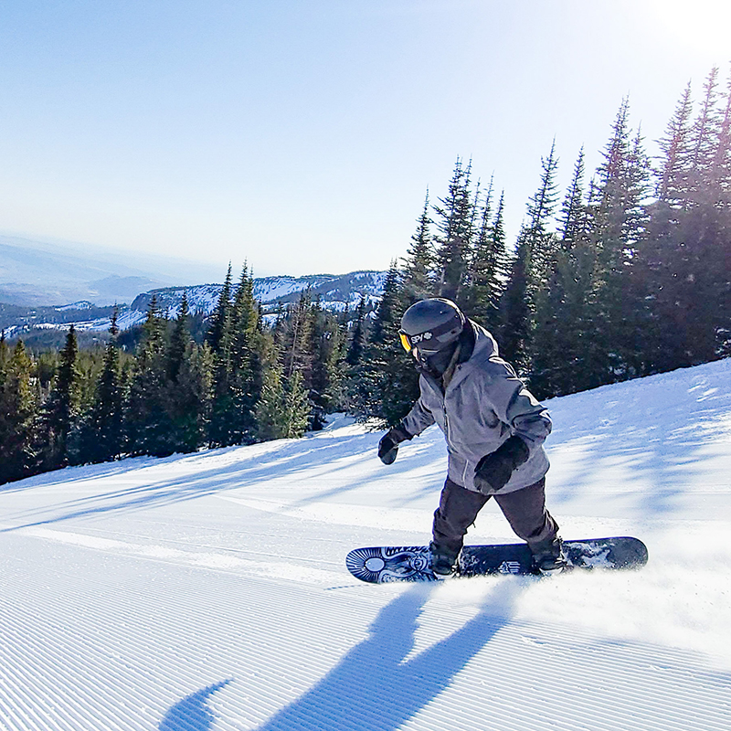 Snowboarder in grey jacket at Mission Ridge.