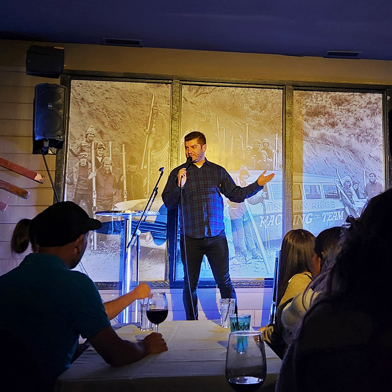 Comedian on stage under spotlight