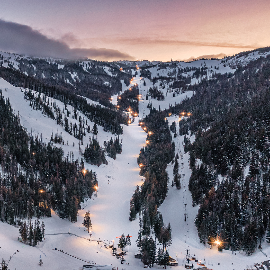 Arial view of Mimi run with lights on and sunset behind