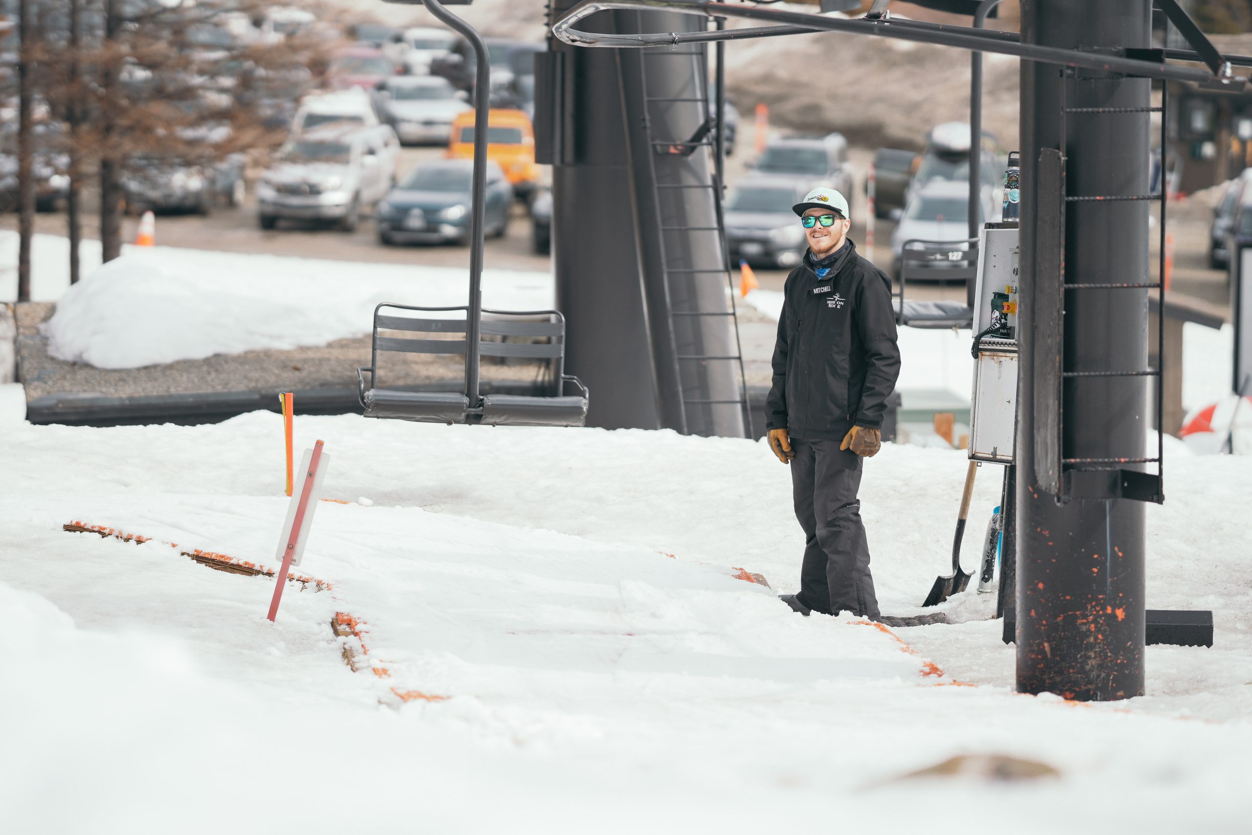 Lift Op in black standing at the bottom of double chair chairlift