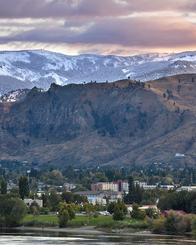 View of Mission Ridge and Wenatchee in the Spring. Wenatchee is green with new growth and Mission Ridge is covered in snow.