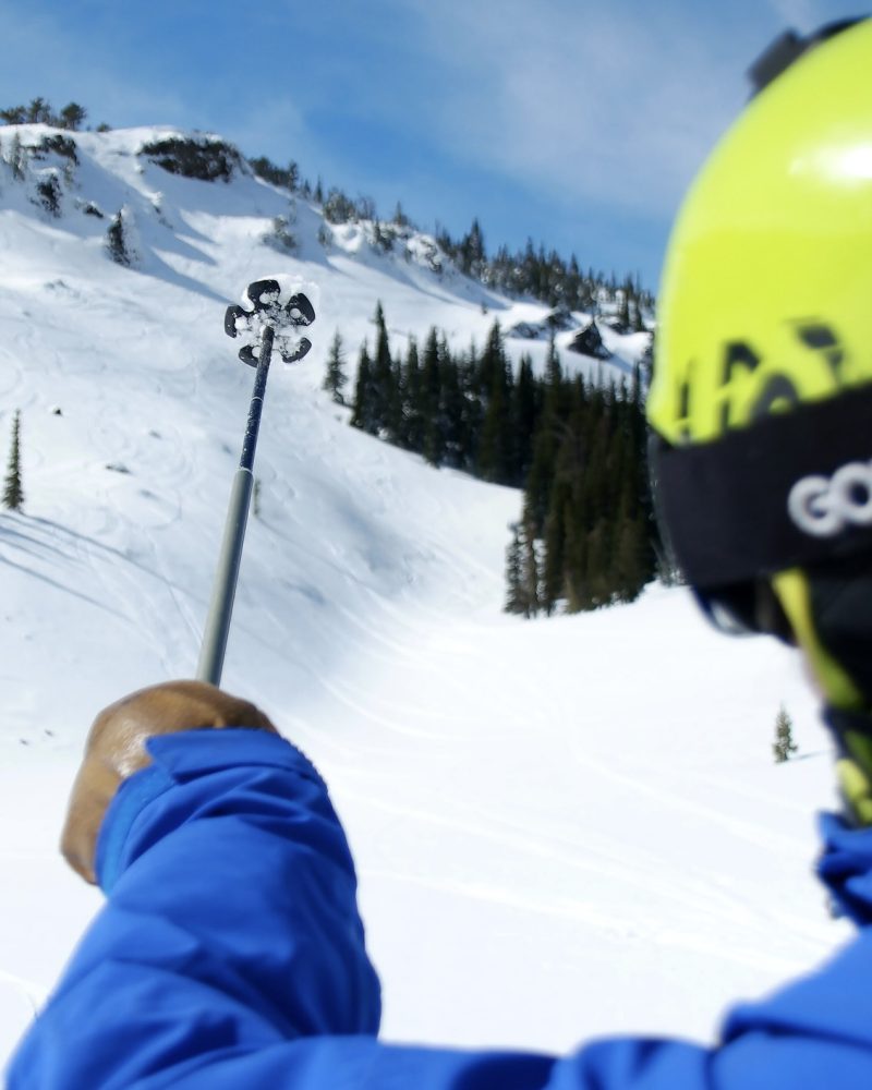 A skier using their ski pole to point at Mission Ridge terrain