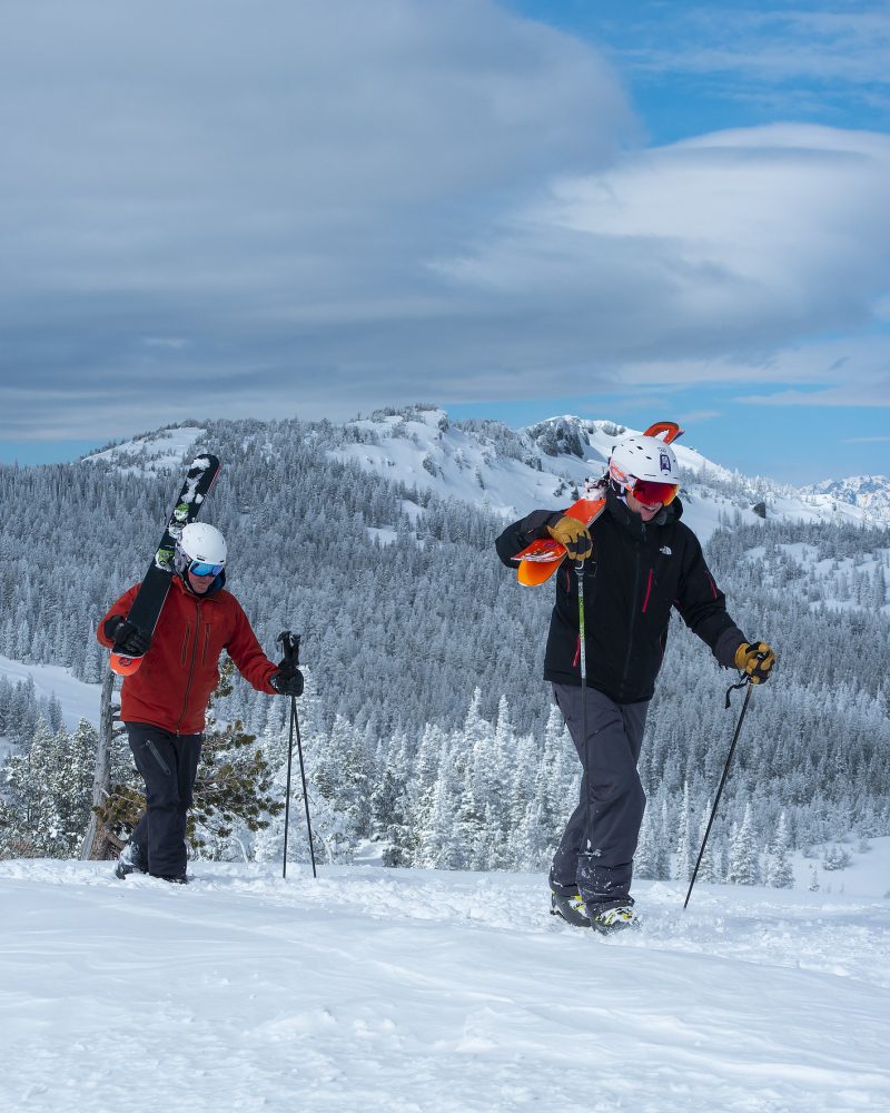 Skiers hiking in the snow with Mission Ridge terrain in the background