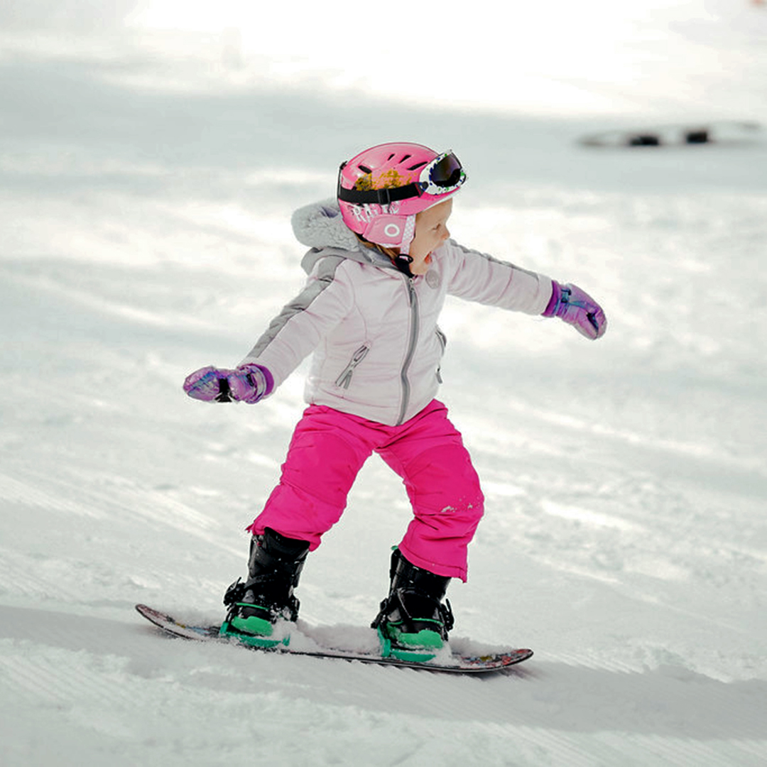 Photo of a girl riding a snowboard at Mission Ridge