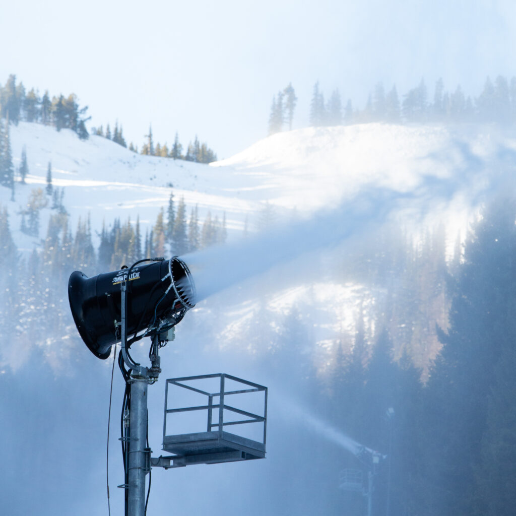 Tower snow gun blowing snow in the air