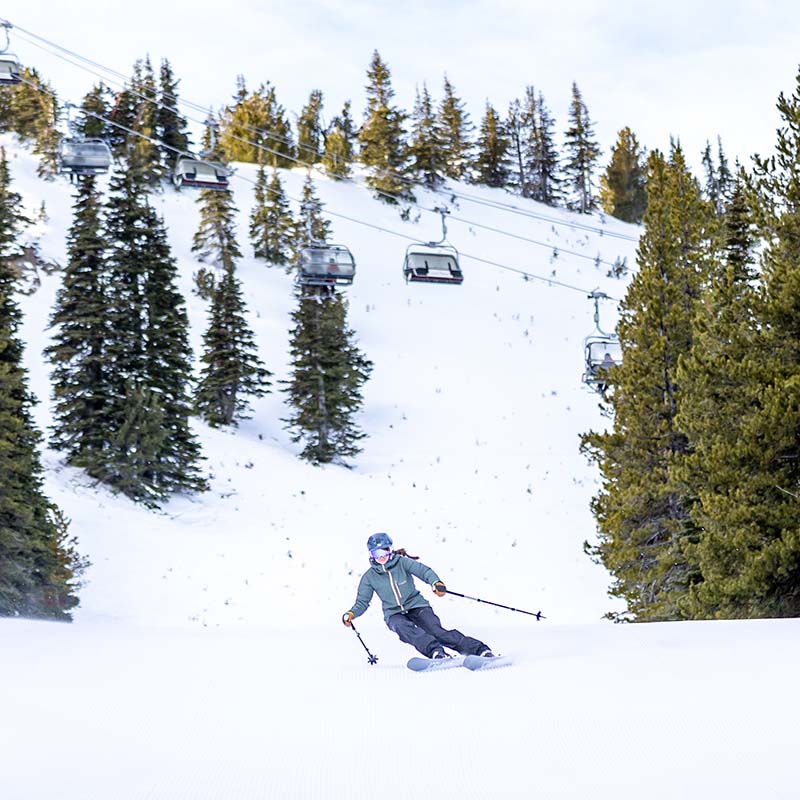Skier making turn on groomed run