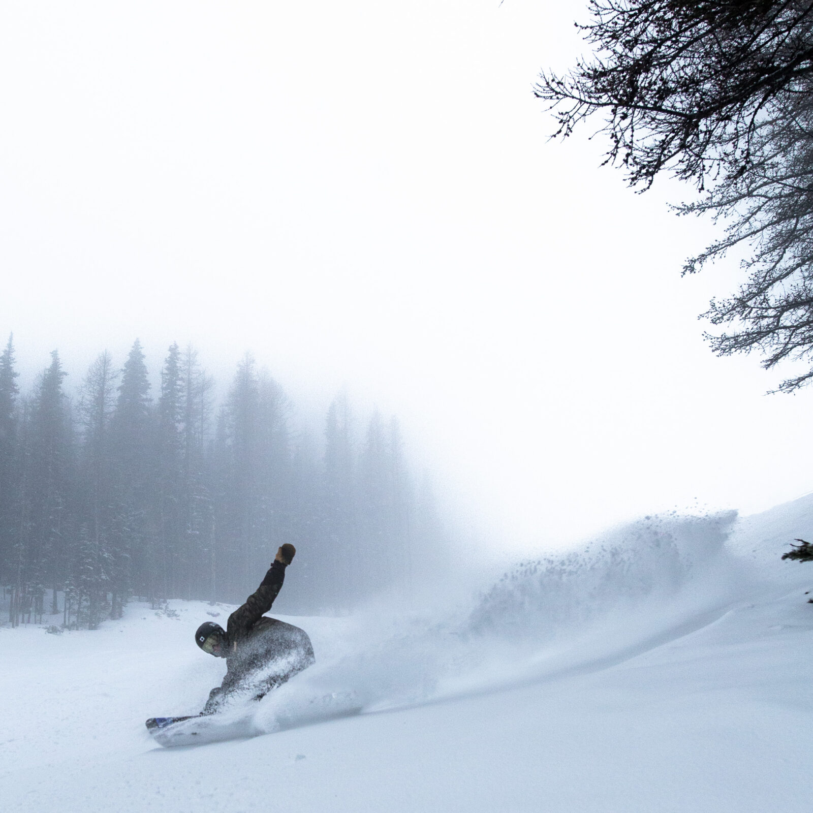 Snowboarding on Tumwater making a pow turn.