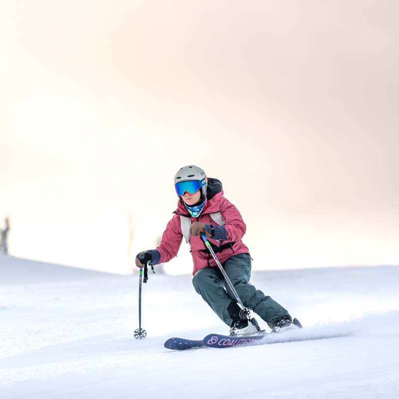Skier on groom with sun behind