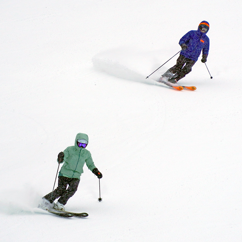 Two skiers in a storm making turns on the Tumwater run at Mission Ridge.