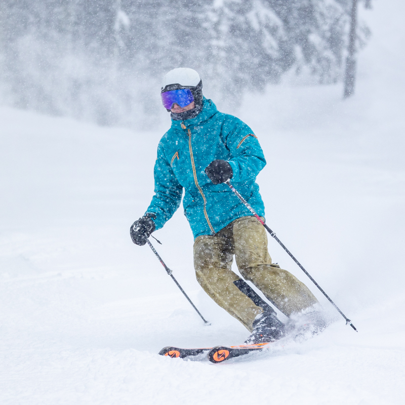 Skier on groomed run snowing heavily