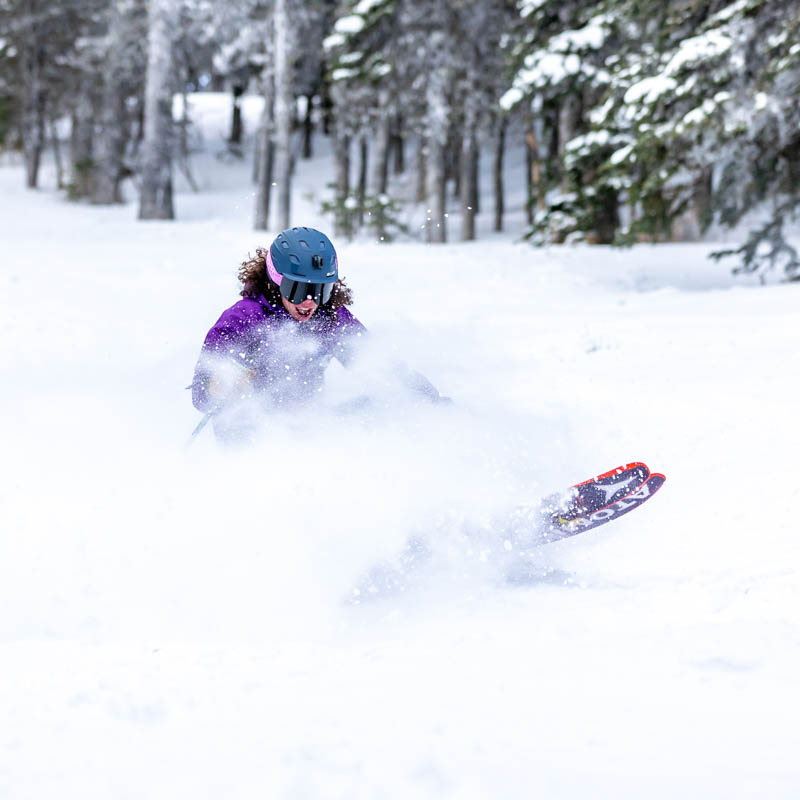 Skier making deep powder turn.