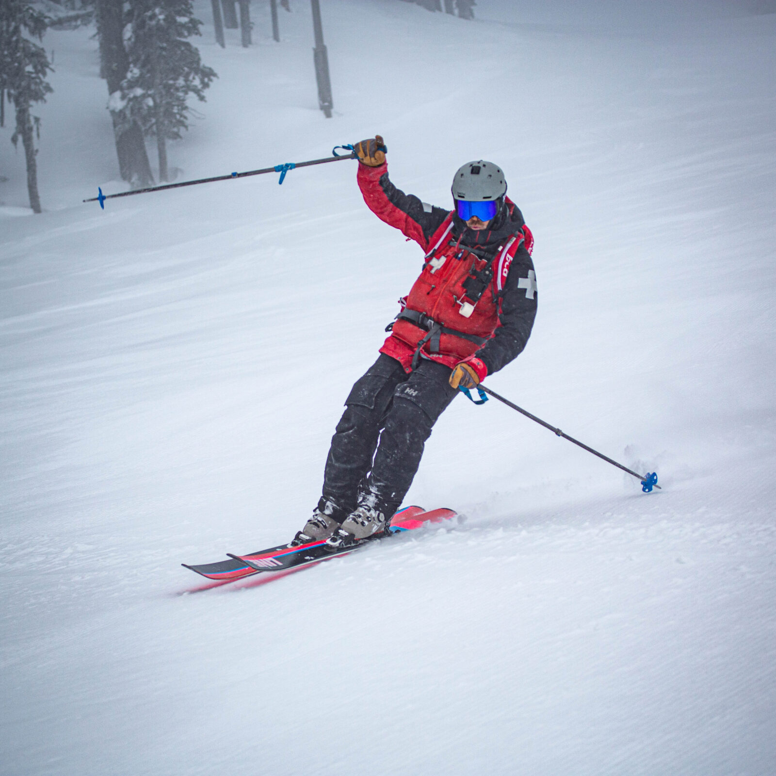 Waving ski patroller carving on Tumwater