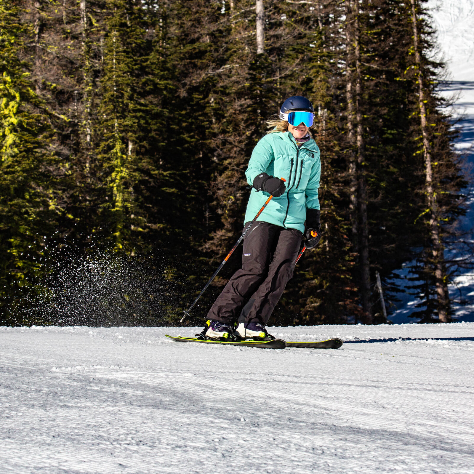 skier in green and black carves out of Ka Wham