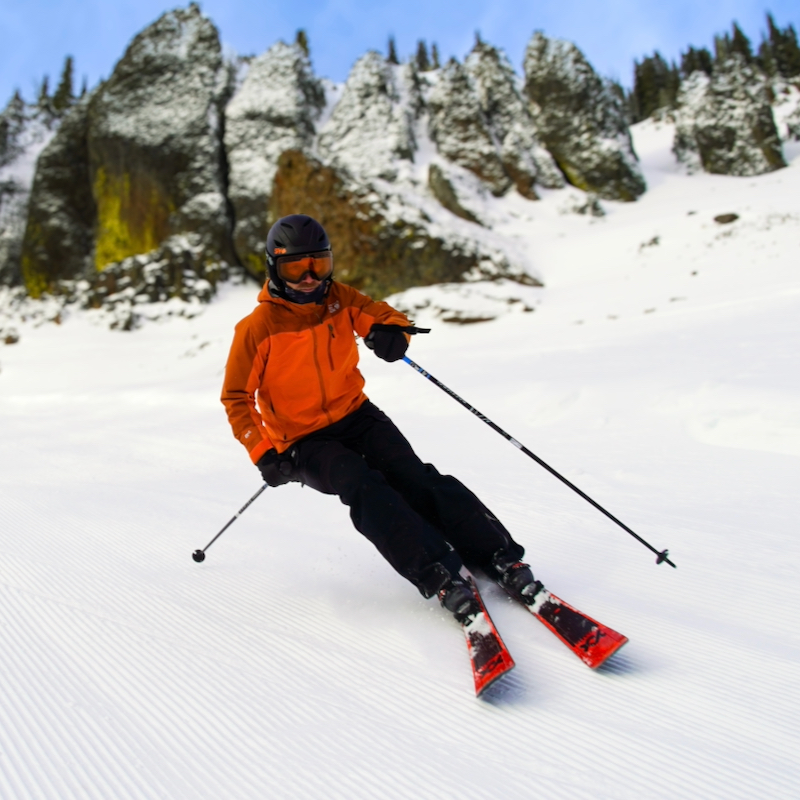 Skier descending the Bomber trail at Mission Ridge beneath the cliffs.