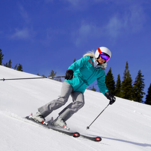 A skier descends the Sunspot Trail at Mission Ridge on a sunny day.