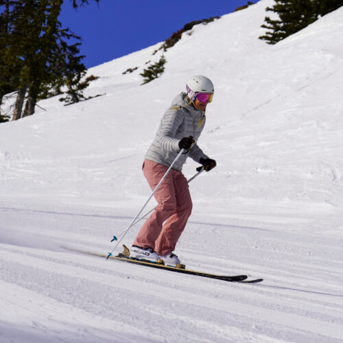 A skier descends the Bomber Trail at Mission Ridge on a sunny day.