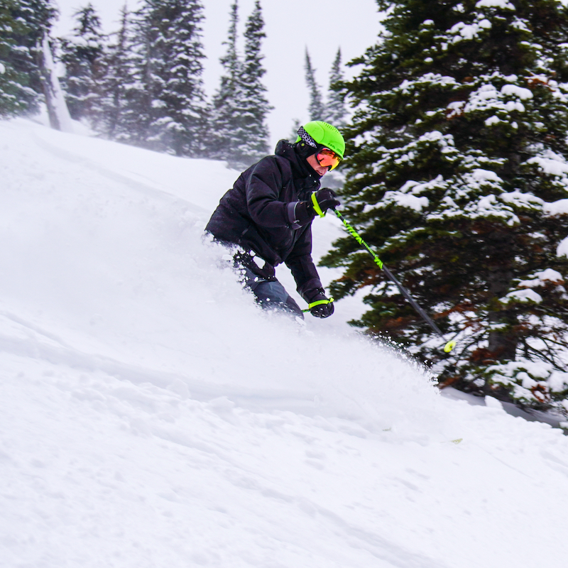 A skier descends the Queens trail at Mission Ridge on a powder day.