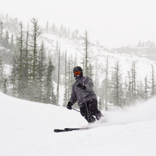 A skier descends the Upper Chak Chak trail at Mission Ridge as fresh snow falls.