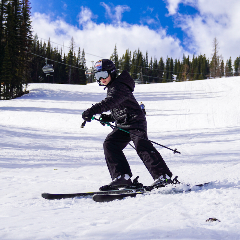 A young skier descends the Nastar trail at Mission Ridge on a sunny day.