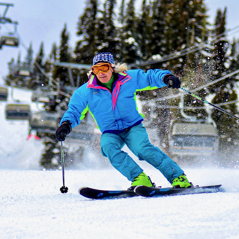 A skier in a neon suit descends the Tumwater trail at Mission Ridge.