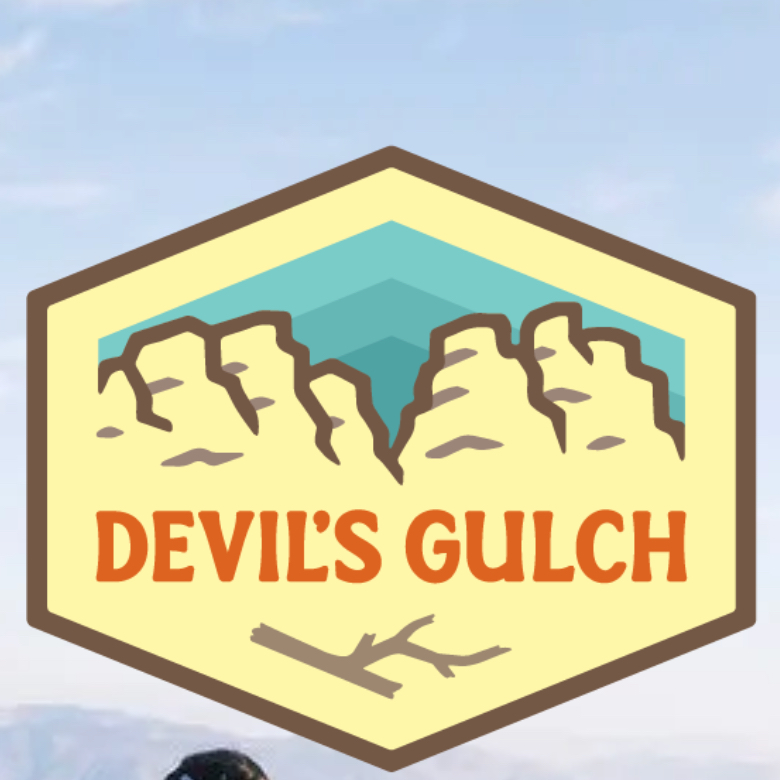 A logo of the Devils Gulch Trail Race featuring the orange text Devils Gulch laid on a beige cartoon drawing of some craggy rock outcroppings.