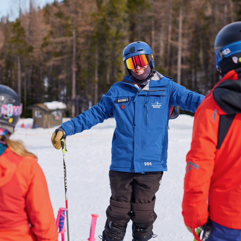 A ski instructor at Mission Ridge chats with two skiers.
