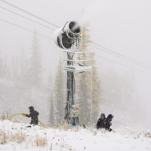 A snowmaking crew works near a snow gun at Mission Ridge during a snowstorm.