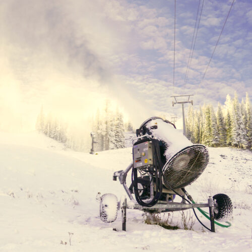 A snow gun blowing snow on the Tumwater Trail at Mission Ridge