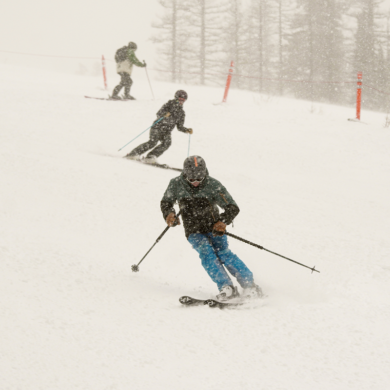 Skiers descend the Tumwater trail at Mission Ridge on a snowy day