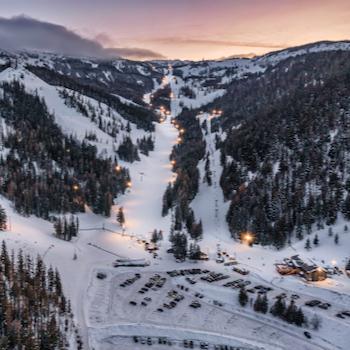 Aerial view of night lights and sunset over Mission Ridge ski area.