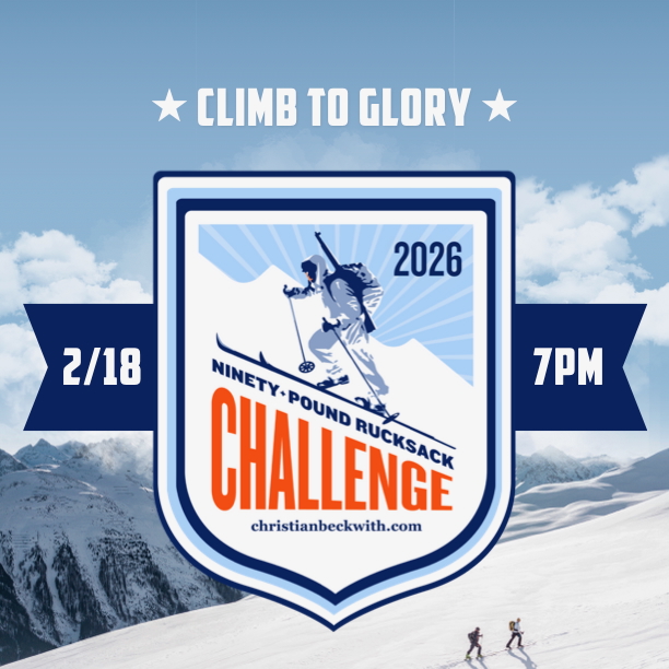 Participant hiking uphill carrying a ninety-pound rucksack as part of the 90-Pound Rucksack Challenge.