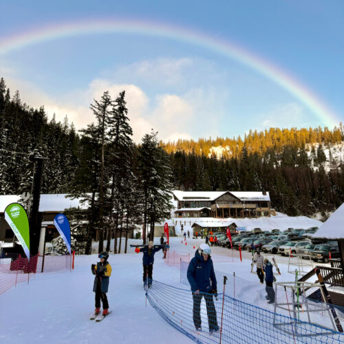 a rainbow amid blue skies over the Pika Peak Learning Area at Mission Ridge