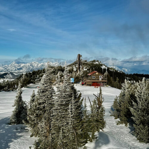 View from the summit of Chair 2 at Mission Ridge, showing the top of a ski run and a summit shack.