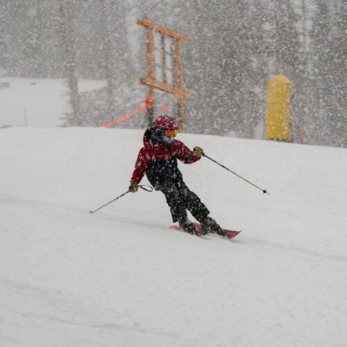 A child navigates a storm storm on skis
