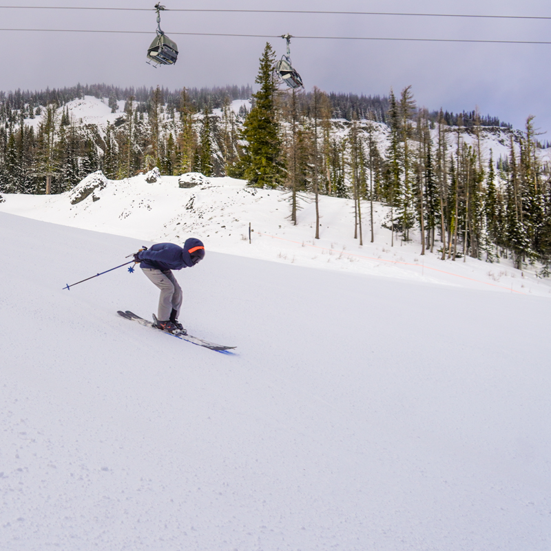 A young skier in a fast tuck