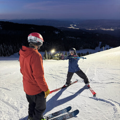 A nighttime ski lesson on Sunspot trail at Mission Ridge with the Wenatchee lights in the background.