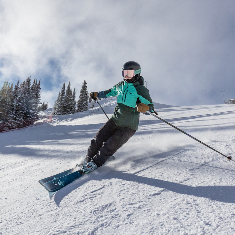 a skier descends the sunspot trail at Mission Ridge on a sunny day.