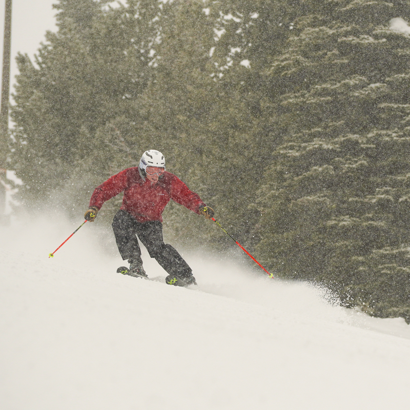 A skier descends the Sunspot Trail at Mission ridge on a snowy day.