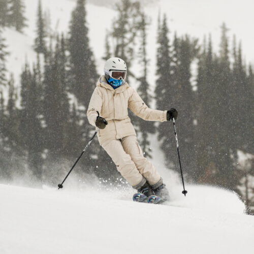 A skier descends the Tumwater trail at Mission Ridge with flurries in the air behind her.