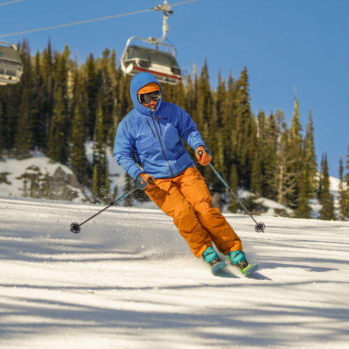 A skier descends the Tumwater trail at Mission Ridge on a sunny day.