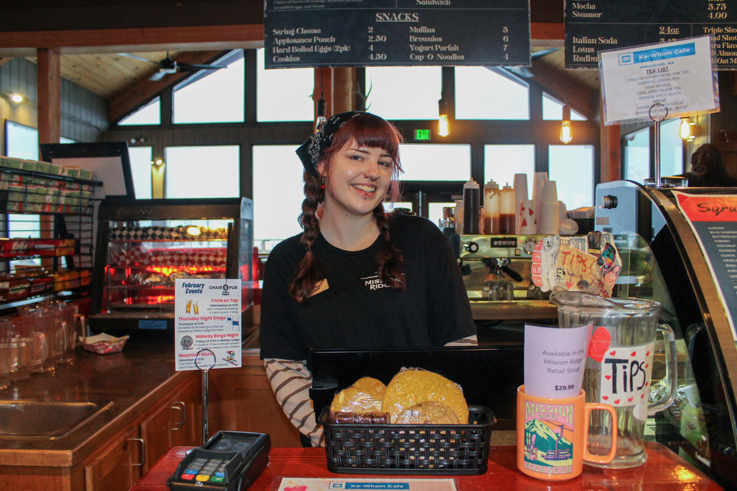 A Mission Ridge bartender stands at the checkout for the Ka-Wham Cafe.