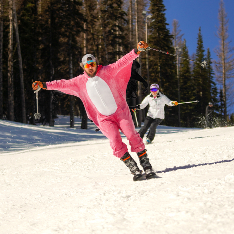 A skier in a flamingo onesie descends the Tumwater Trail at Mission Ridge.