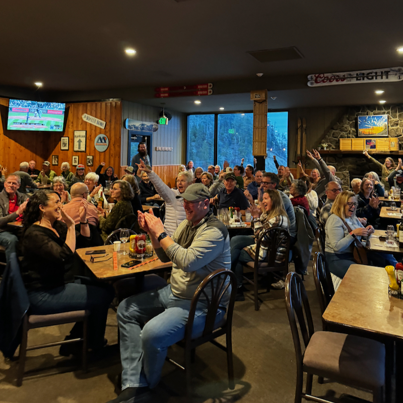 A crowd cheers at a benefit dinner for Badger Mountain at Mission Ridge.