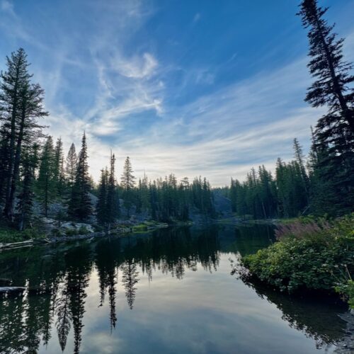 Lake Clara in the evening time reflecting blue sky and clouds.