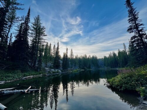 Lake Clara in the evening time reflecting blue sky and clouds.