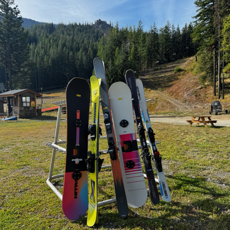 Skis and snowboards lean up against a rack in the Mission Ridge base area.